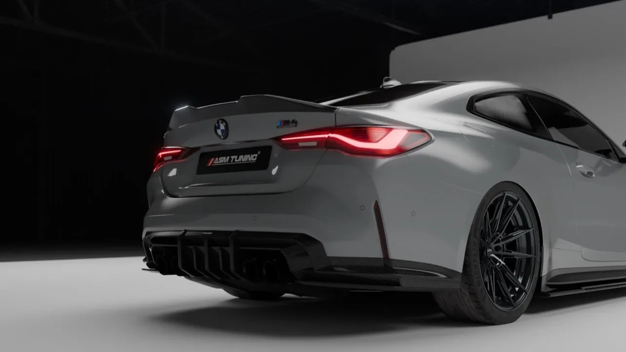 Rear view of a BMW M4 with an installed carbon fibre rear diffuser by ASM Tuning, showcasing perfect fitment and aggressive styling