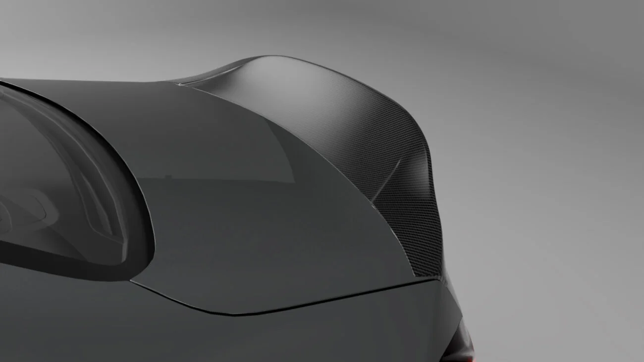 Close-up of a carbon fiber spoiler installed on a dark green performance car trunk, demonstrating perfect fitment