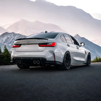 BMW M3 G80 with V Style carbon fibre spoiler installed, rear angle showing high-kick trunk lip for improved downforce and styling