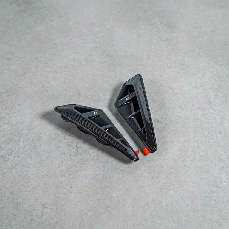 BMW X5M F95 carbon fibre side fenders M-Performance style – front angle view with gloss carbon finish and aerodynamic vents