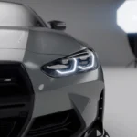 Detailed close-up of headlight and ASM carbon bumper duct on BMW M4 G82/G83