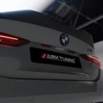 Low angle of BMW M4 G82 showcasing trunk spoiler and logo