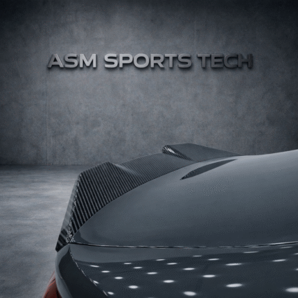 Angled rear quarter view of grey BMW M4 G82 showing the ASM pre-preg carbon fibre trunk lip spoiler installed