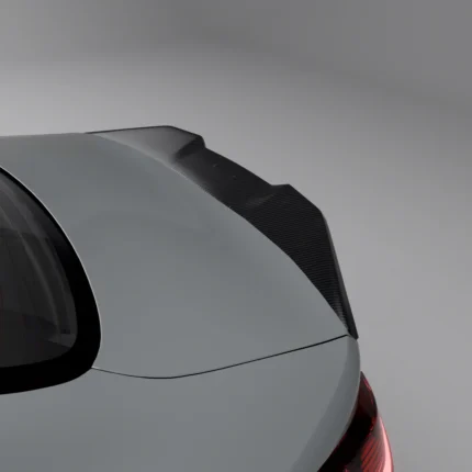 Top close-up of pre-preg carbon fibre spoiler installed on grey BMW G82, highlighting weave and aggressive contour