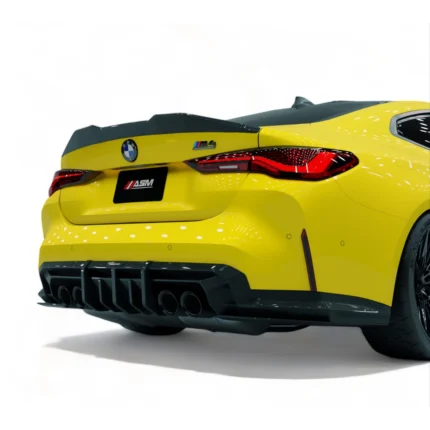 Angled rear quarter view of yellow BMW M4 G82 showing the ASM pre-preg carbon fibre trunk lip spoiler installed