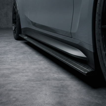 Straight close-up of carbon fibre side skirt running beneath grey BMW M4 G82 door line