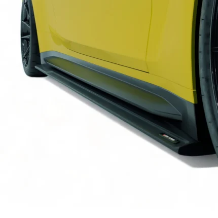 Straight close-up of carbon fibre side skirt running beneath grey BMW M4 G82 door line