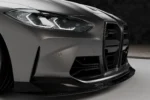 BMW M4 G82 G83 carbon fibre front ducts shown from three-quarter angle with refined OEM+ bumper integration