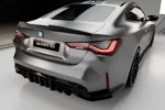 BMW M4 G82 G83 dry carbon rear diffuser shown from rear three-quarter angle with wider lower rear stance