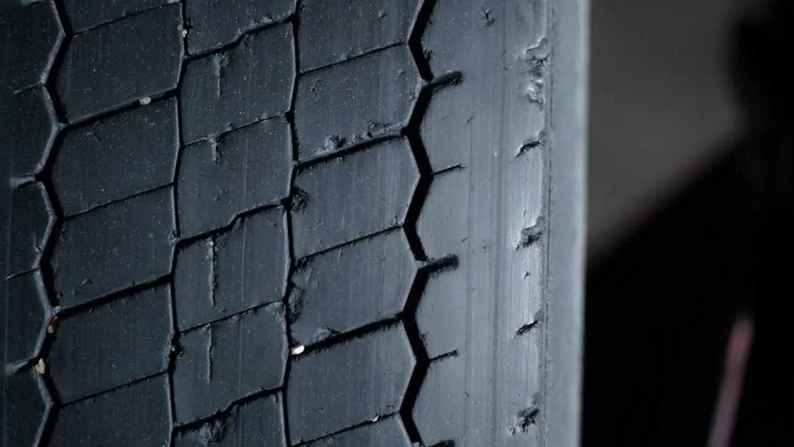 Close-up of tire tread showing camber tire wear patterns.