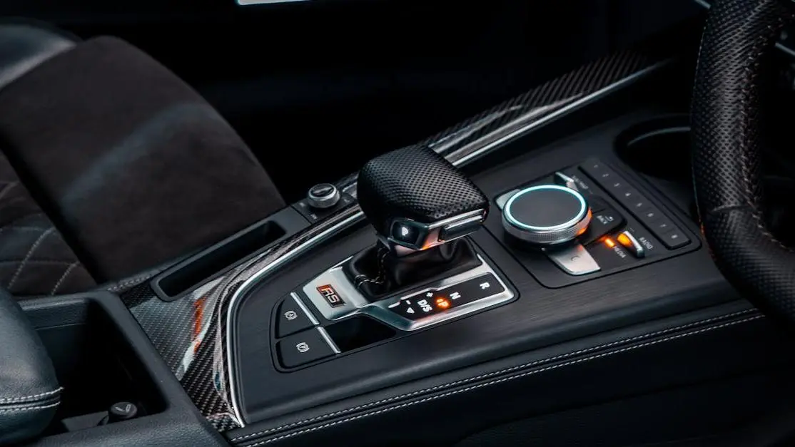 Short shifter installation in a modern luxury car.