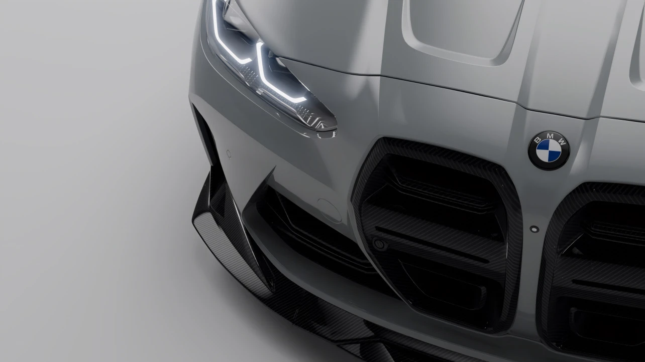 Close-up of BMW G82 M4 front end with carbon fiber splitter, grilles, and vents, showcasing modern performance styling for 2025 builds