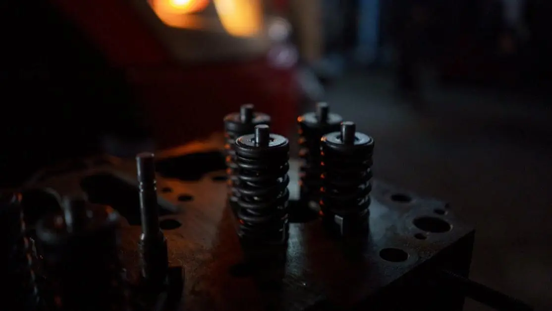 Engine comparison: coilovers vs lowering springs in a workshop setting.