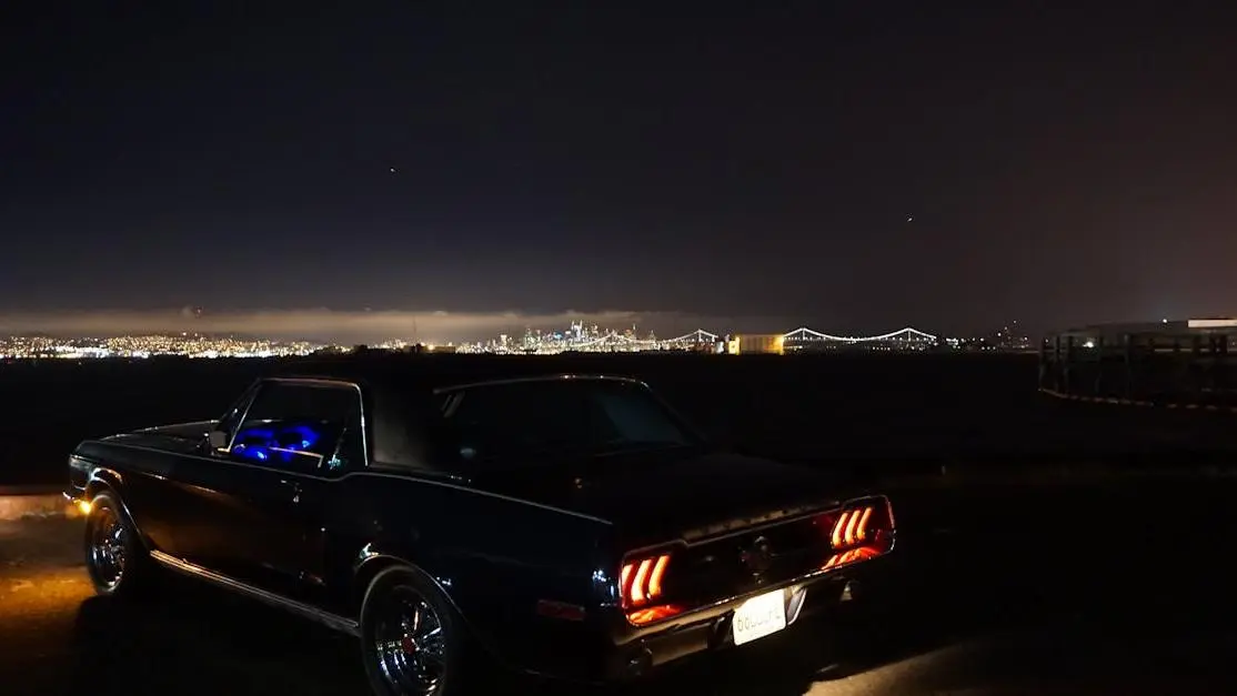 Mustang with underglow lights by waterfront, showcasing how to install underglow lights.