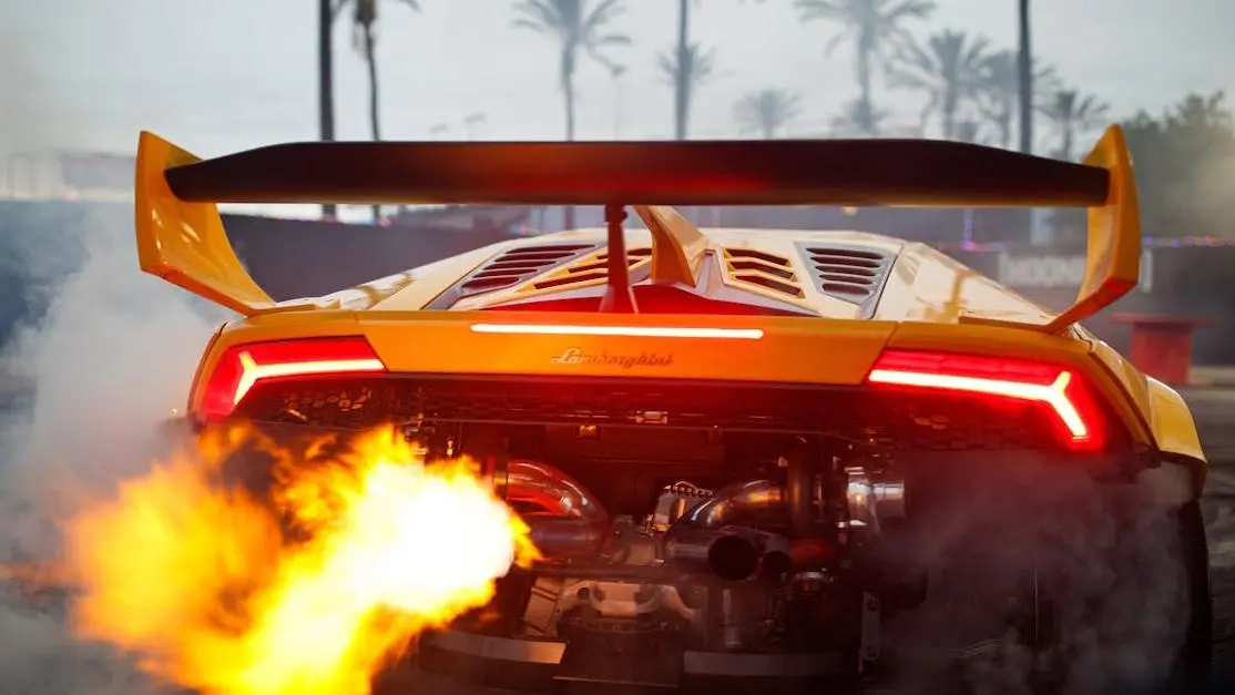 Yellow sports car with straight pipe exhaust illustrating pros and cons against palm trees background.