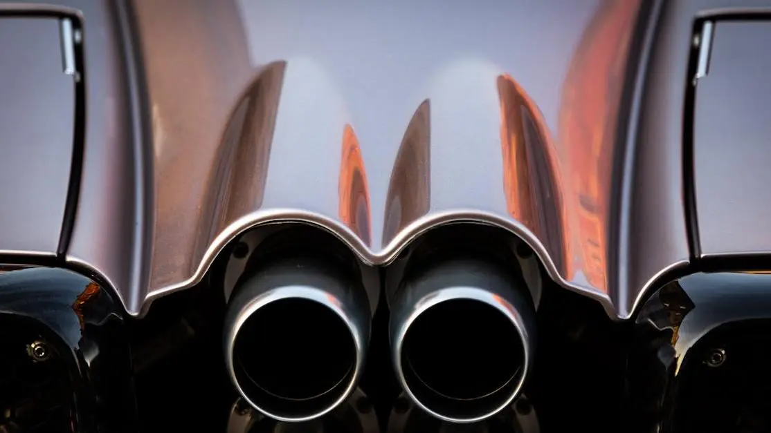 Catless downpipe vs catted comparison on twin exhaust pipes of a luxury sports car