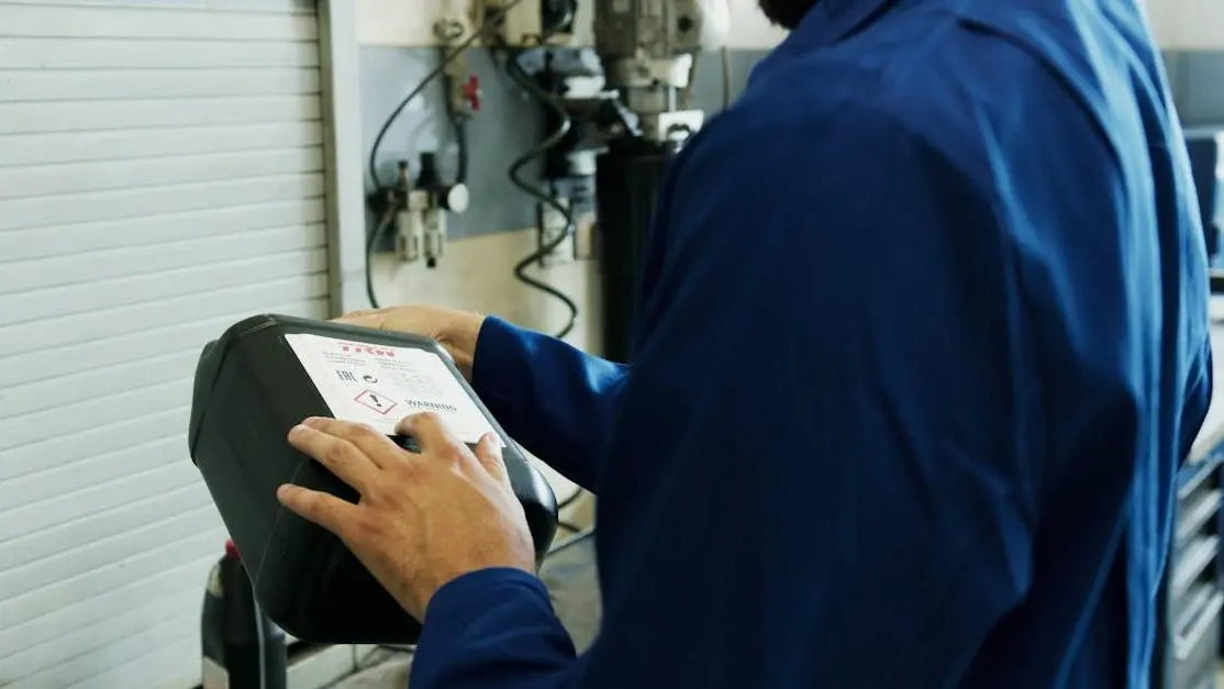 Mechanic performing ECU tuning, does ecu tuning void warranty concept in auto workshop.