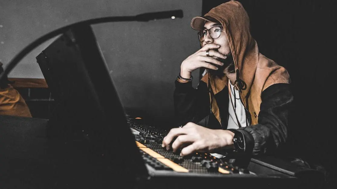 Music producer adjusting audio equipment, illustrating open loop vs closed loop tuning in studio.