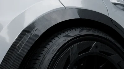 Macro detail of carbon fibre fender flare curvature on Porsche Cayenne Turbo GT Coupe
