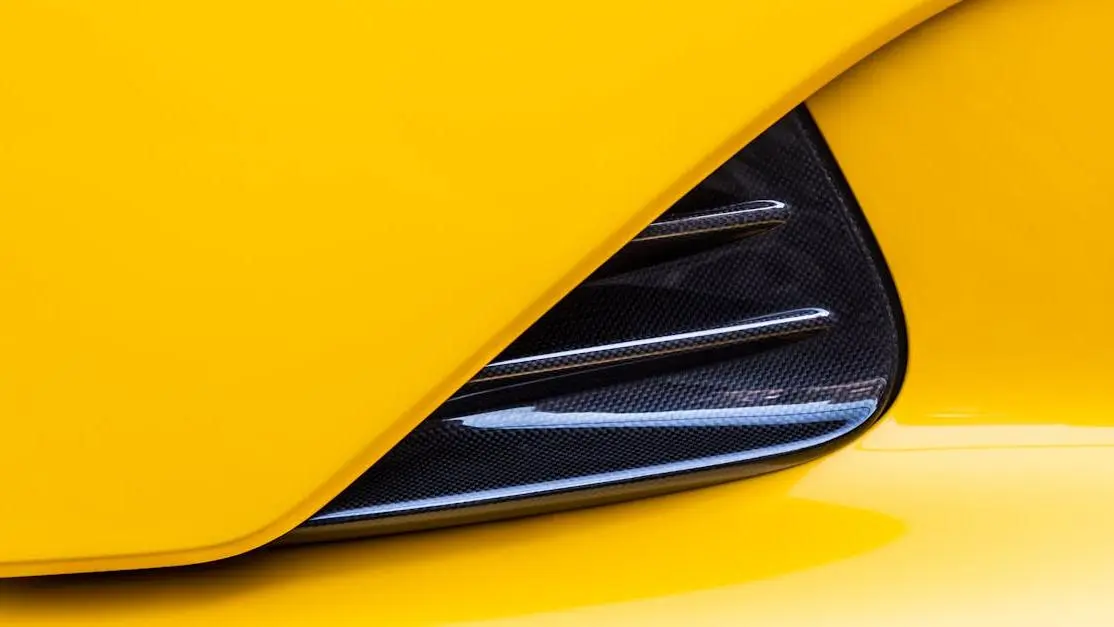 Yellow supercar carbon fiber vent showcasing advanced automotive performance design