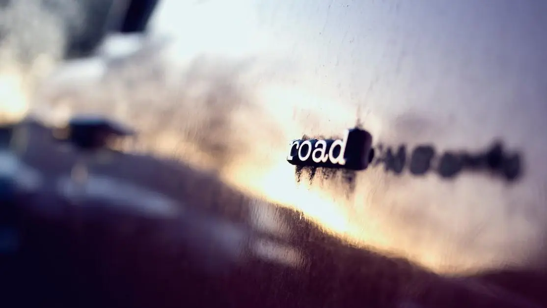 Close-up of a car emblem reflecting sunset, showcasing modern automotive styling and design.