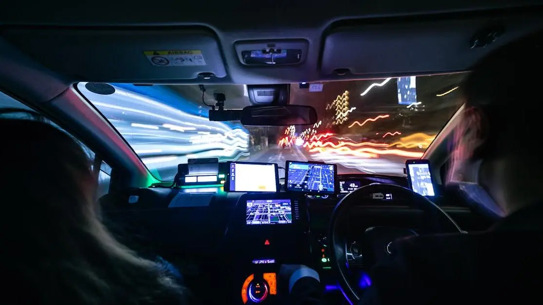Night drive in Kyoto showcasing vibrant city lights and motion blur, symbolizing automotive innovations