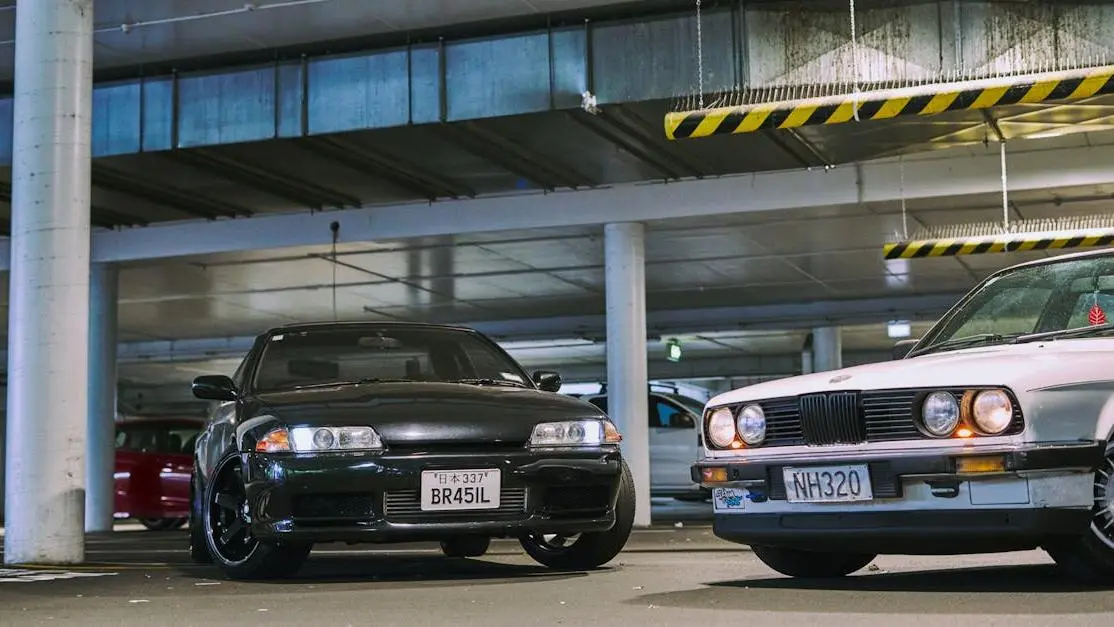 Modified sports cars with performance parts for cars in an urban parking garage setting