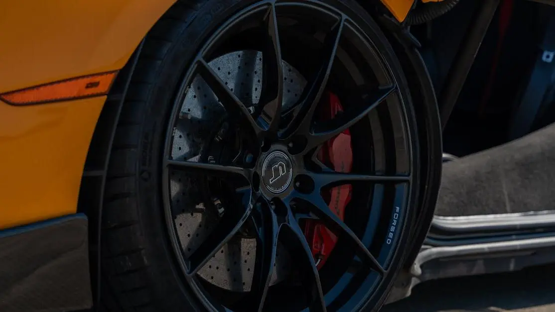 Black sports car wheel with carbon ceramic brakes in Illinois featuring car high performance parts