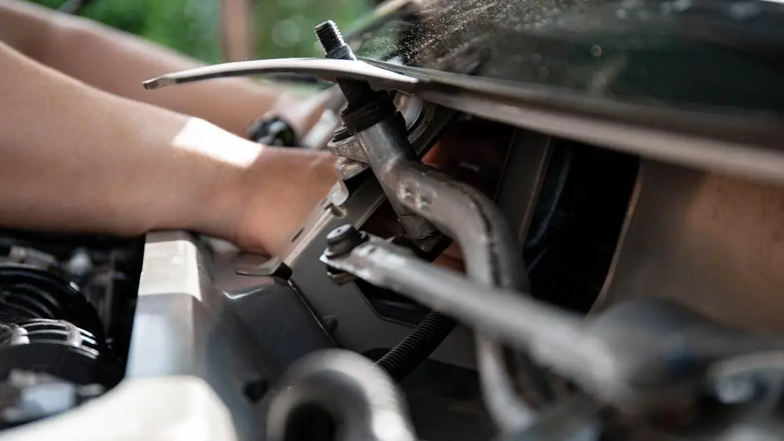 Mechanic’s hands adjusting engine components and tools during car performance tuning close-up