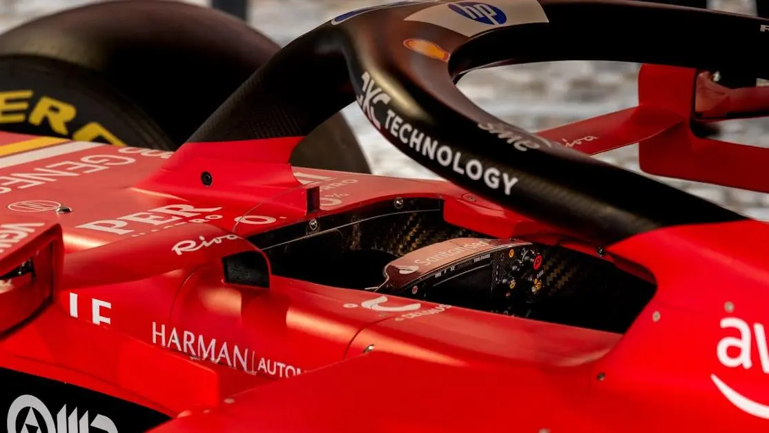 Close-up of red Formula One cockpit highlighting race car components and sponsor branding