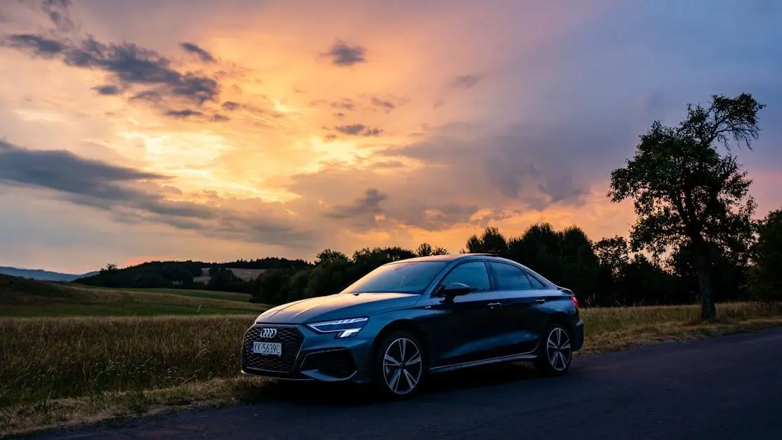 Audi racing parts showcased on a sleek Audi sedan at sunset in the Slovak countryside