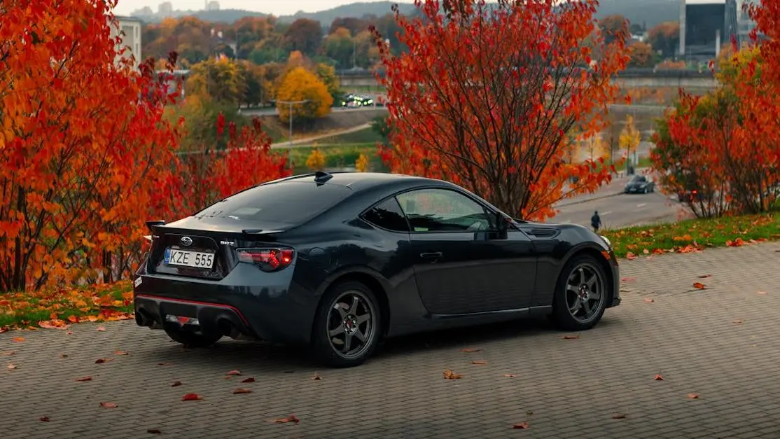 Shiny black Subaru BRZ with autumn leaves, highlighting a sleek body kit for Subaru BRZ cover photo