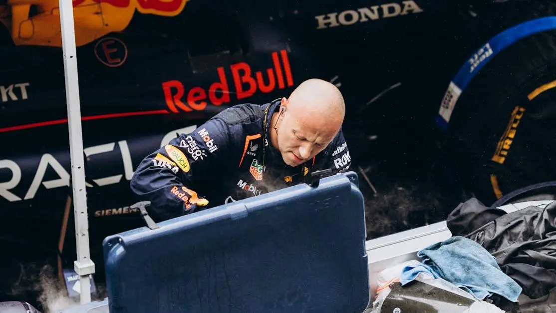 Red Bull pit stop with crew servicing car, highlighting Formula 1 chassis components and design