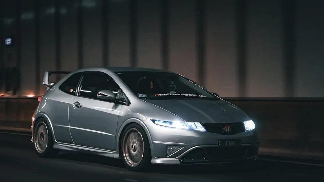 Silver Honda speeding through a dim tunnel at night, symbolizing performance optimization