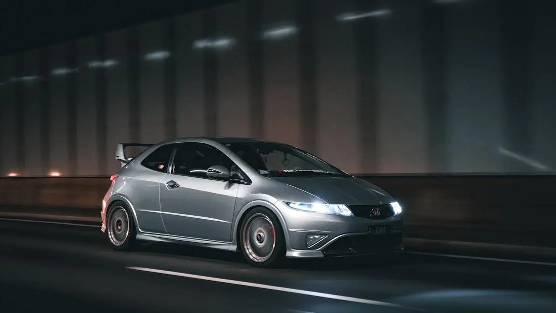 Query optimization concept illustrated by a sleek silver sports car speeding through a dim tunnel