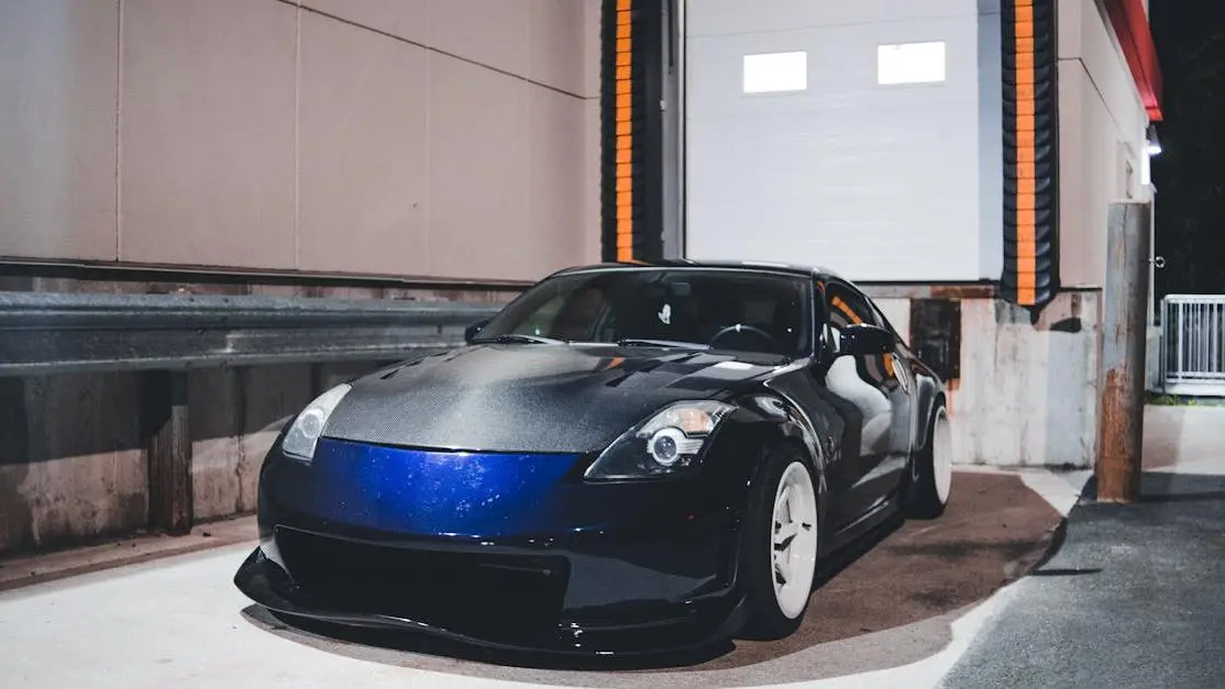 Sleek customized Nissan 350Z at night in industrial lot showcasing car customization parts