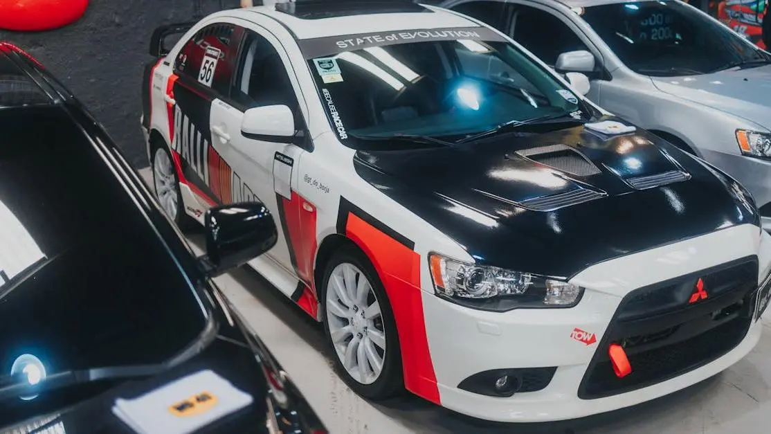 Customized Mitsubishi Lancer Evolution featuring performance custom car parts in a garage display