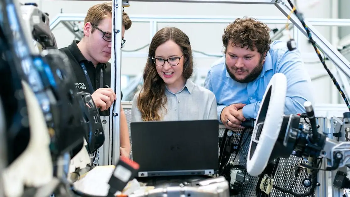 Engineers performing professional car tuning in a modern workshop with advanced diagnostic tools