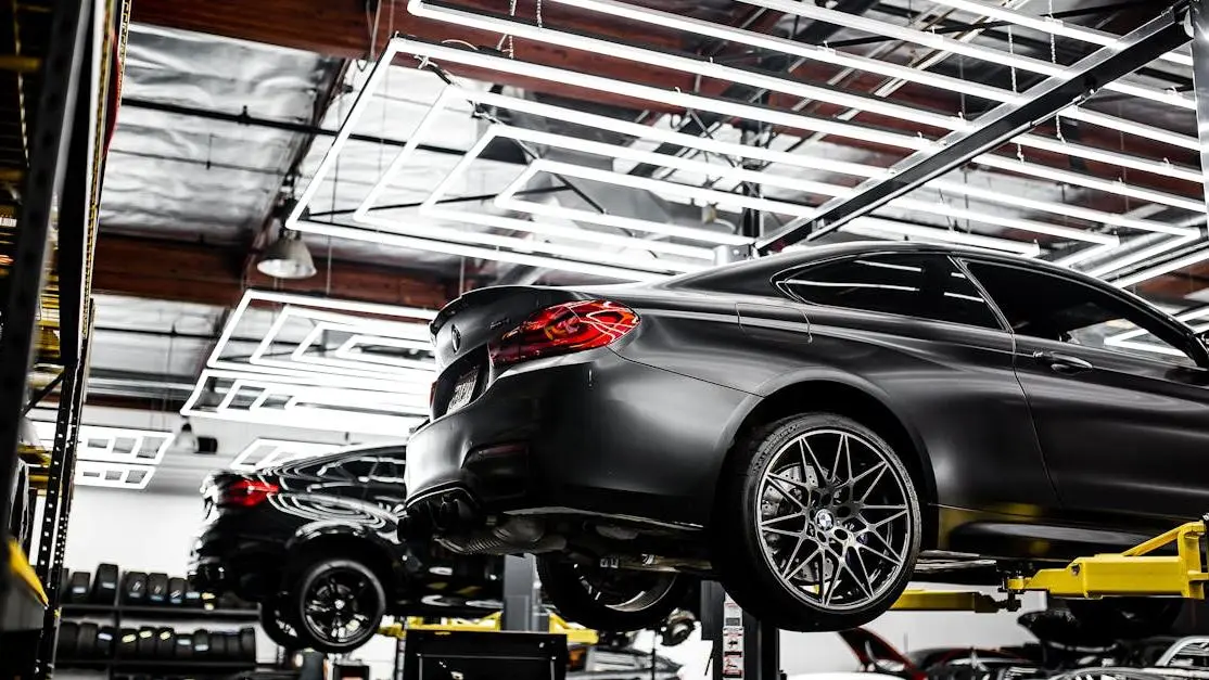 Modern car repair shop with vehicles on lifts, highlighting Robert Bosch GmbH Automotive Aftermarket tools