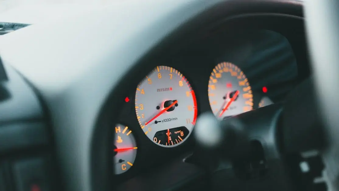 Close-up dashboard with illuminated speedometer and tachometer, metaphor for SQL optimization performance