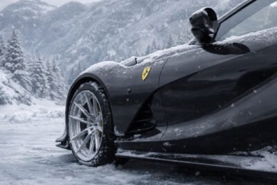 Performance Car With Carbon Fiber Aero Components Driving In Snowy Winter Conditions, Highlighting The Need For Proper Carbon Protection