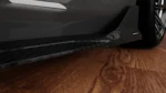 BMW G87 M2 dry carbon side skirts front side angle showing connection with lower side aero and OEM+ styling