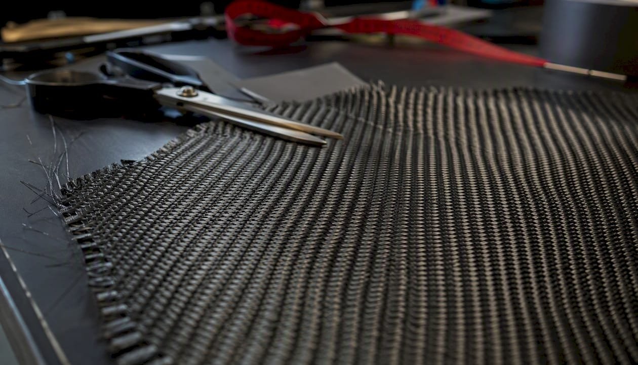 Close-Up Of Carbon Fiber Fabric Weave On Cutting Mat